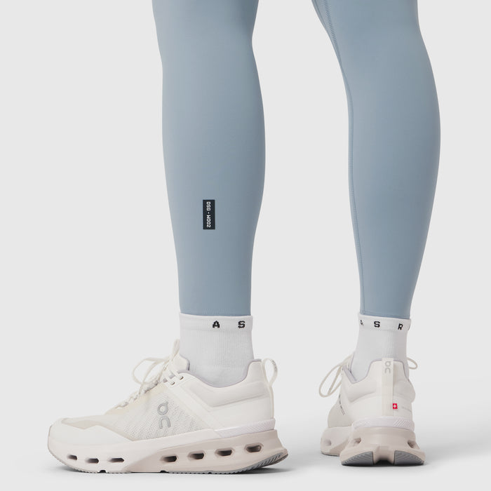 Model wearing light sky LYCRA® ADAPTIV leggings with white socks and white sneakers, front and back view