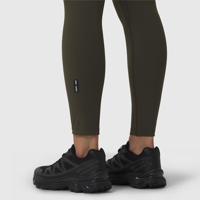W002 LYCRA® ADAPTIV legging in olive worn with black sneakers, lower body view