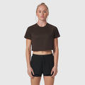 AeroSilver® cropped tee in dark earth, worn with black shorts, front view on model