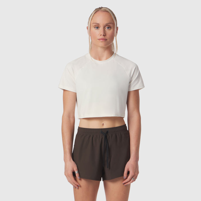 AeroSilver Cropped Tee in ivory cream worn with black shorts, front view