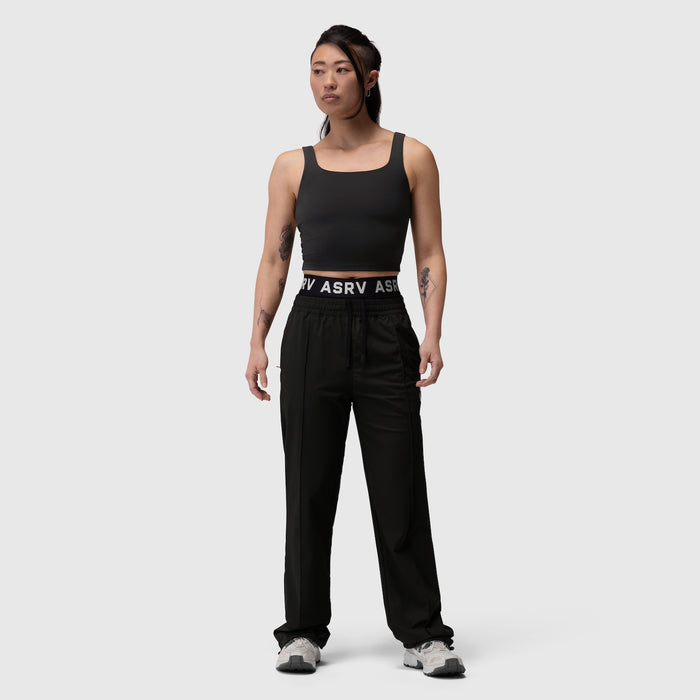 Black LYCRA® 2-in-1 tank top worn by model standing against neutral background