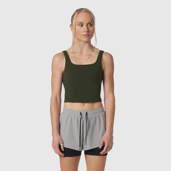 Olive LYCRA® 2-in-1 tank top worn with gray shorts, front view on model