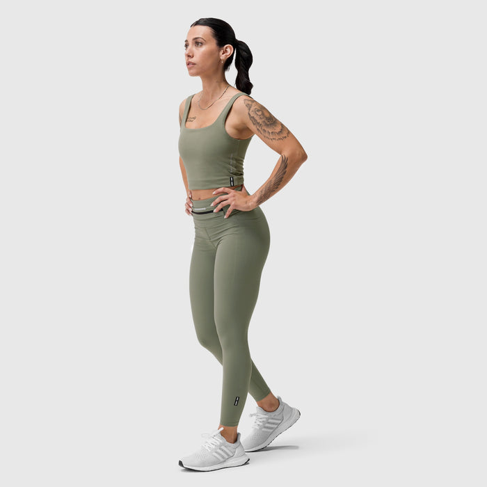 LYCRA® 2-in-1 tank top in sage, worn by model standing in profile