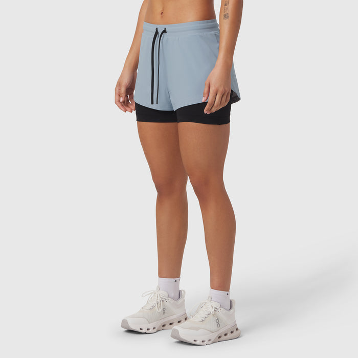 Tetra-Lite Liner Short in light sky and black, worn by model with white sneakers