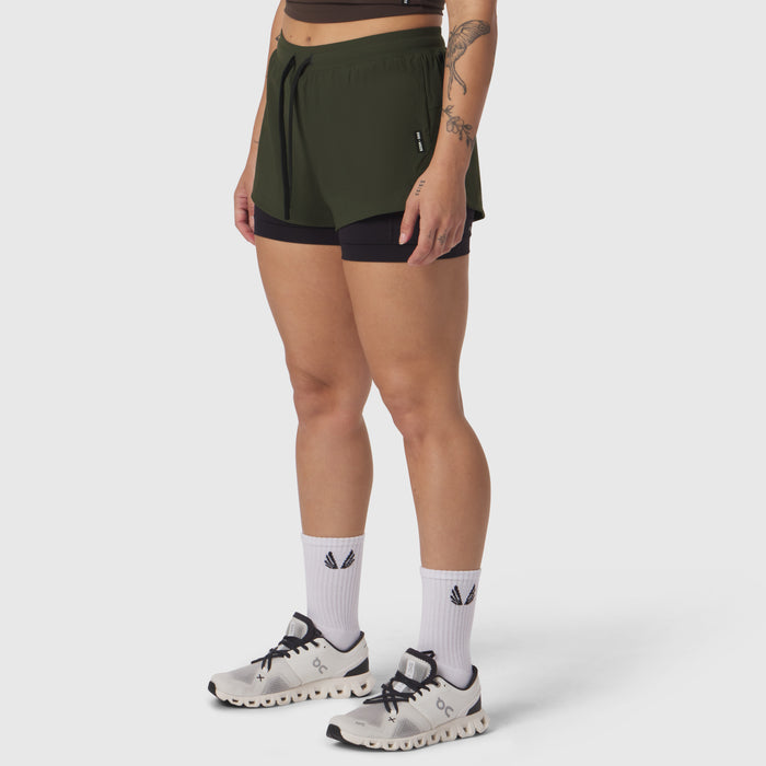 Tetra-Lite Liner Short in olive with black undershorts, modeled with white socks and trail sneakers