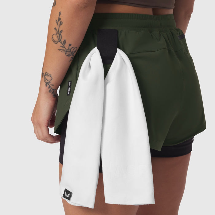 Tetra-Lite® Liner Short in olive worn by model, back view with white towel