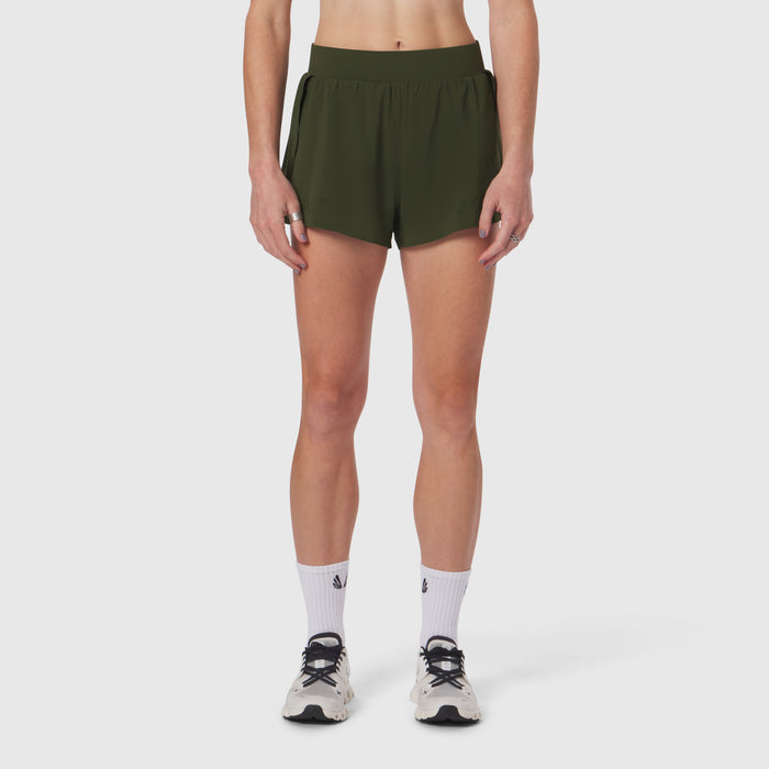 Aerotex Side Split Run Short in olive, modeled on woman with white socks and running shoes