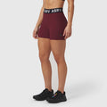 ASRV Lycra Ribbed Short in crimson, worn by model with black sneakers, front view