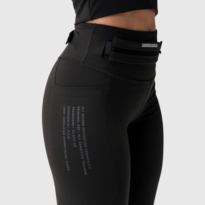 W030 Lycra 3-in-1 legging in black, worn by model showing side view with utility pocket detail