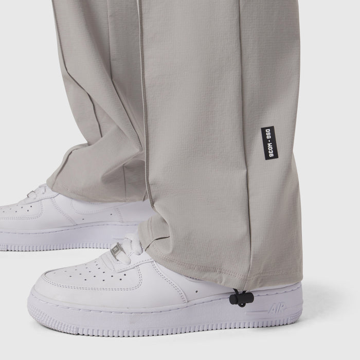 W036 Ripstop Relaxed Track Pant in slate grey worn with white sneakers, detail view of ankle cuff