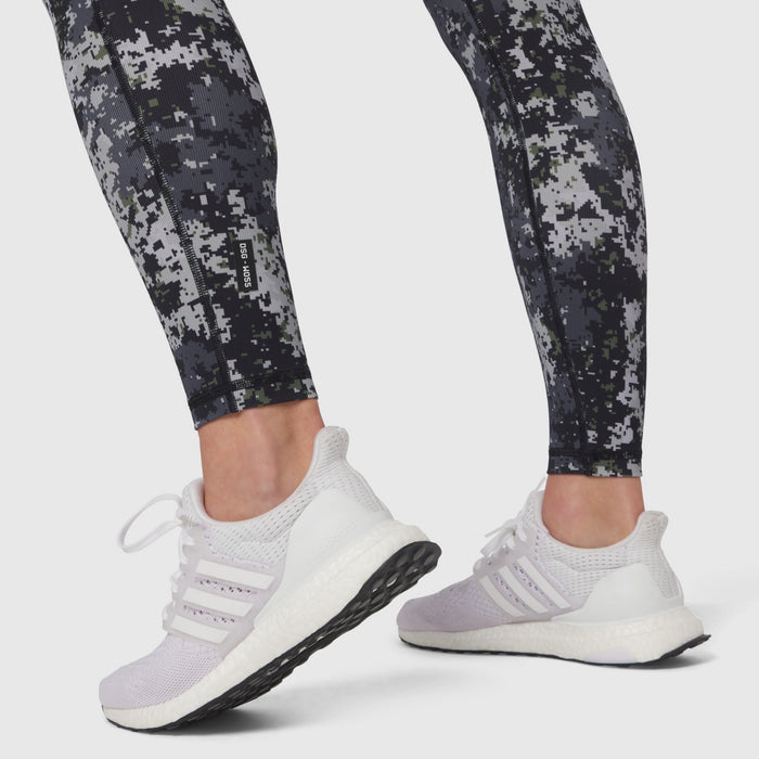 W055 Lycra Ribbed Running Tight in pixel camo worn with white sneakers, side view