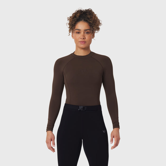 LYCRA® ADAPTIV Baselayer Longsleeve in Dark Earth, worn with black leggings, front view