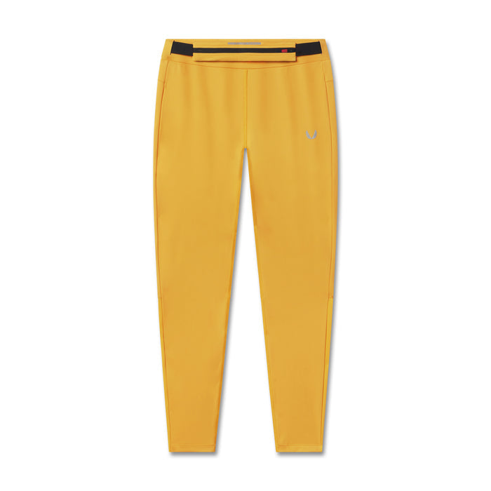 flatlay Hybrid Belt-Pack Run Legging in amber yellow, front view