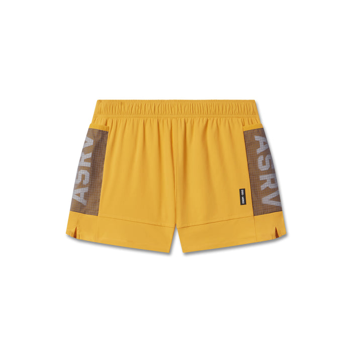 flatlay Tetra-Lite Adventure Short in amber yellow with brown side panels, front view