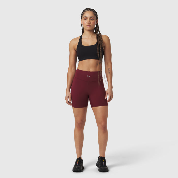 Crimson LYCRA® ADAPTIV biker shorts worn with black sports bra, front-facing pose