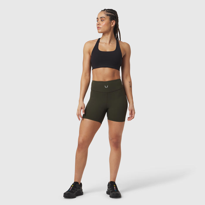 LYCRA® ADAPTIV Biker Short in olive, worn by model standing against neutral background