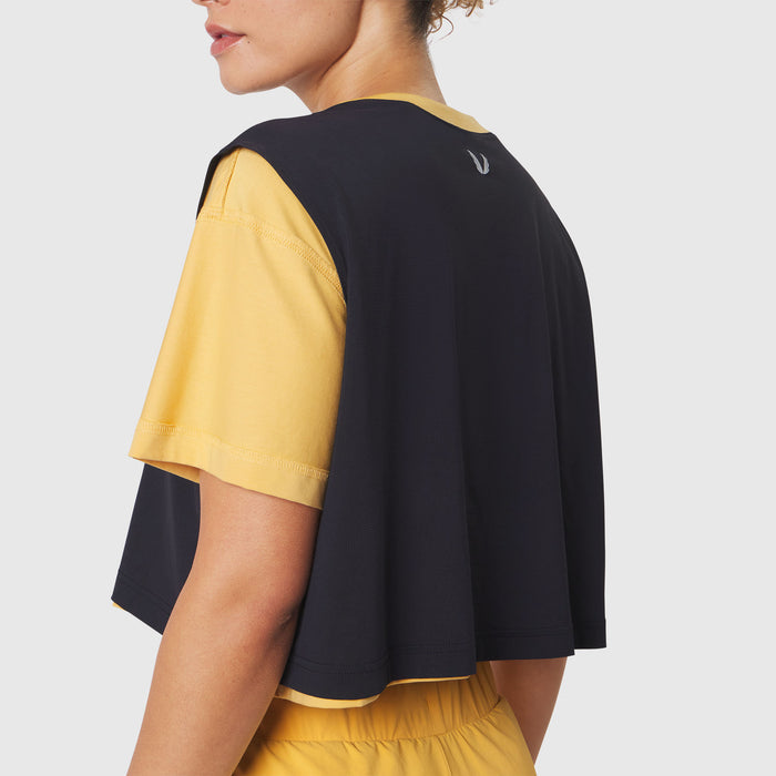 Reversible crop tee in amber and black, back view on model