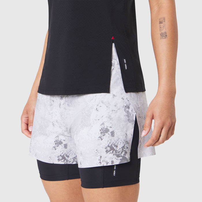 Aerotex Perforated Run Tank in black with marble print shorts, front view on model