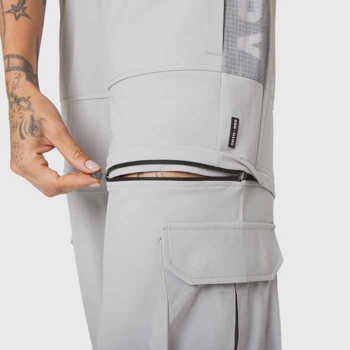 W100 2-in-1 Convertible Pant in Slate Grey, worn with zip pocket detail visible