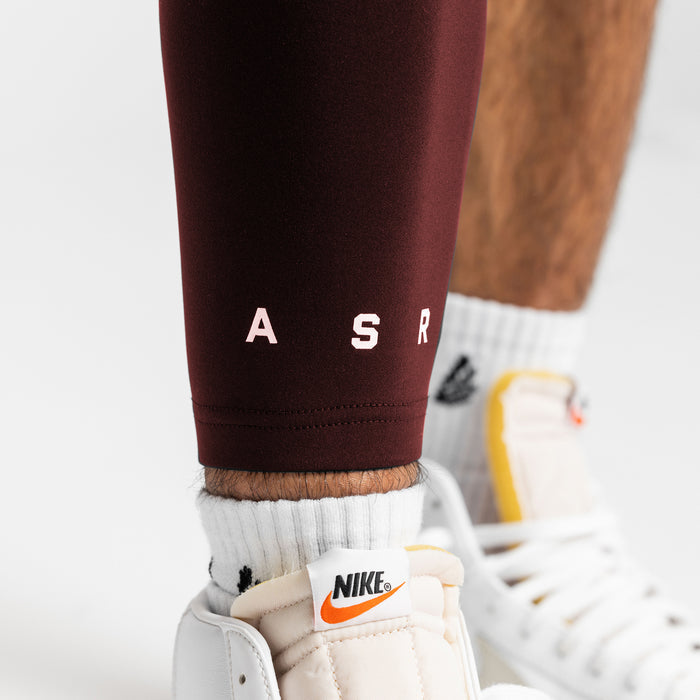 WarpFlexx® Leg Sleeve in crimson worn with white socks and white sneakers, detail view