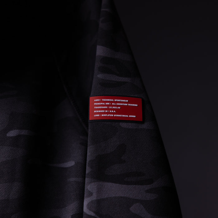 WN'19 RainPlus® Hoodie detail shot showing red care label on dark fabric