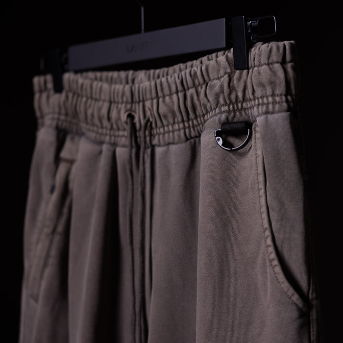 WN'20 Terry Relaxed Jogger in taupe, hanging on display with detail of pocket and drawstring