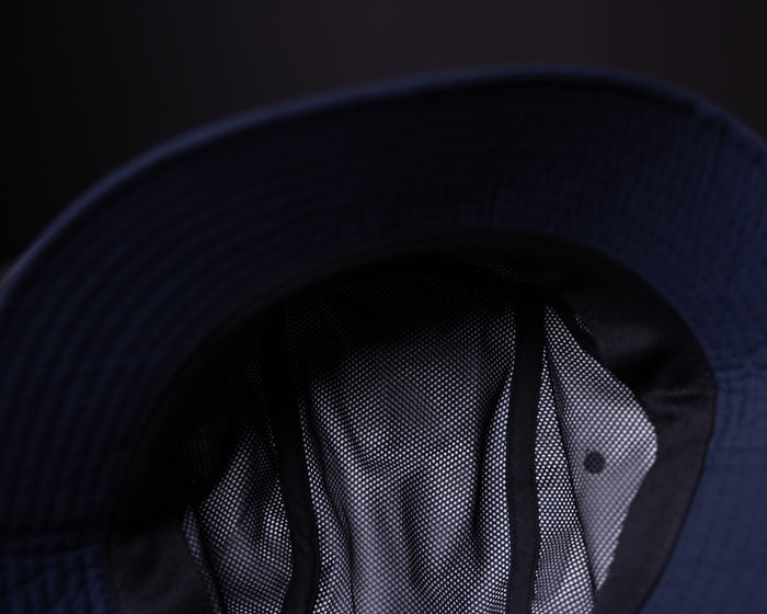 WN'22 Cinch Bucket Hat in navy, worn with mesh detail visible from front angle