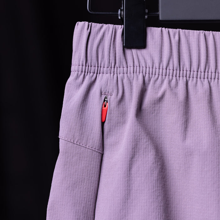 WN'23 6" Perforated Short in lavender, detail shot of pocket and zipper