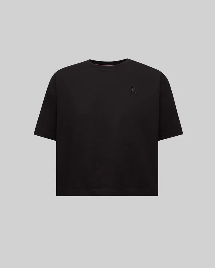 Women's Camille Oversized Fit Tee, a black oversized jersey knit t-shirt featuring a small embroidered black Psycho Bunny skull logo on the left chest and pink neck tape.