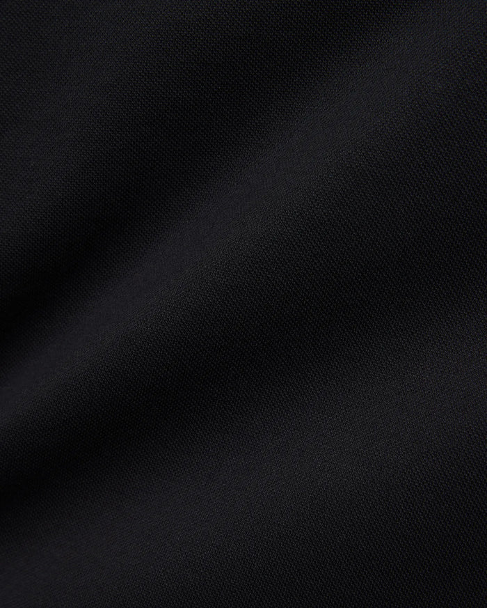 Women's Clara Pique Dress in rich, solid black, highlighting the premium, breathable pique knit fabric with its subtle, textured weave, reflecting Psycho Bunny's refined streetwear aesthetic.