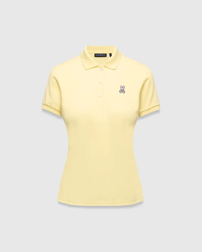 Women's Classic Pique Polo in pale yellow, featuring a classic fit, pique knit fabric, and a small embroidered pink and purple Psycho Bunny skull logo on the left chest.