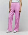 Womens Daisie Fleece Joggers in bright pink, with a relaxed wide-leg fit, soft fleece texture, small embroidered bunny skull logo on the left thigh, and white piped side leg slits.
