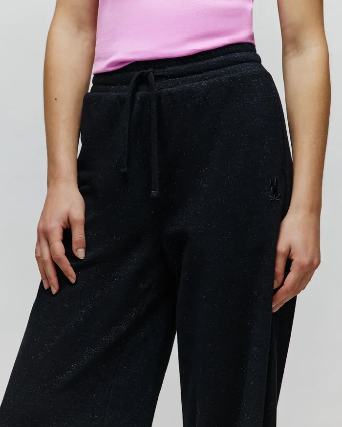 Womens Jules Lurex Sweatpant, black relaxed fit with subtle silver lurex sparkle, featuring a drawstring waist and a small tonal embroidered Psycho Bunny skull logo on the right hip.