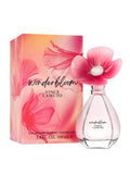 A 3.4 oz bottle of Vince Camuto Wonderbloom Eau de Parfum Spray, featuring a clear, elegant design with a pink flower-shaped cap, is displayed next to its coordinating pink floral-patterned box. This enchanting fragrance captures the essence of white freesia and refreshing pear leaves for a truly captivating scent experience.